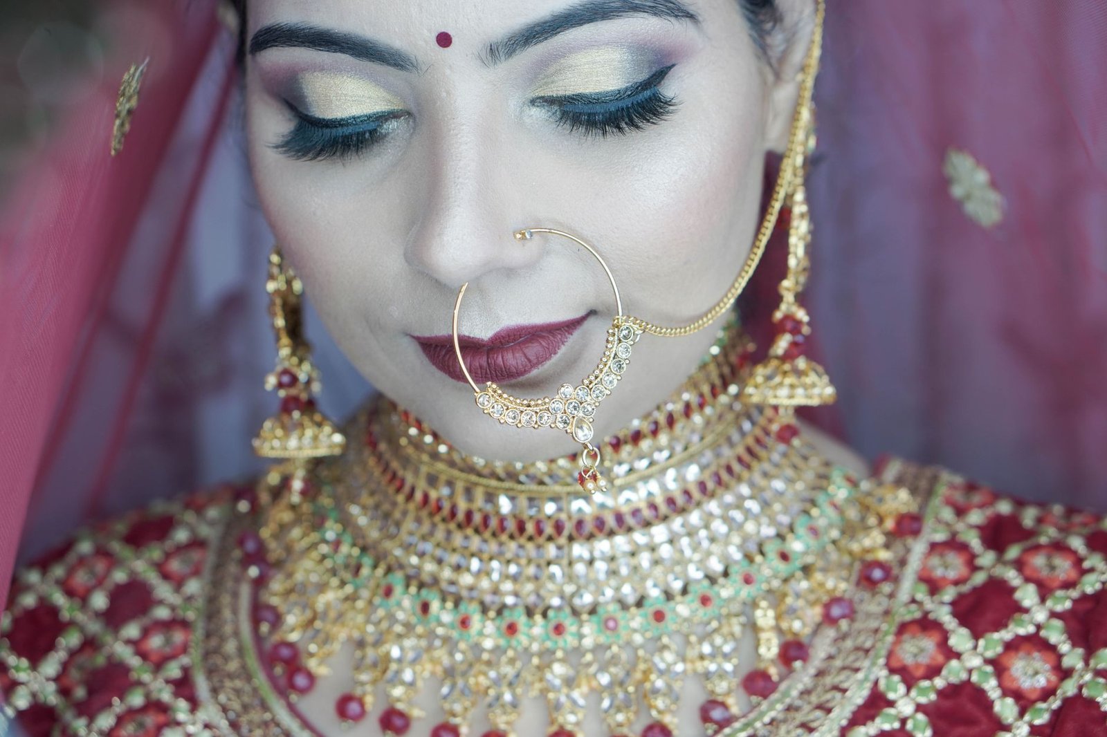 Exquisite close-up of an Indian bride in traditional attire, showcasing beautiful jewelry.