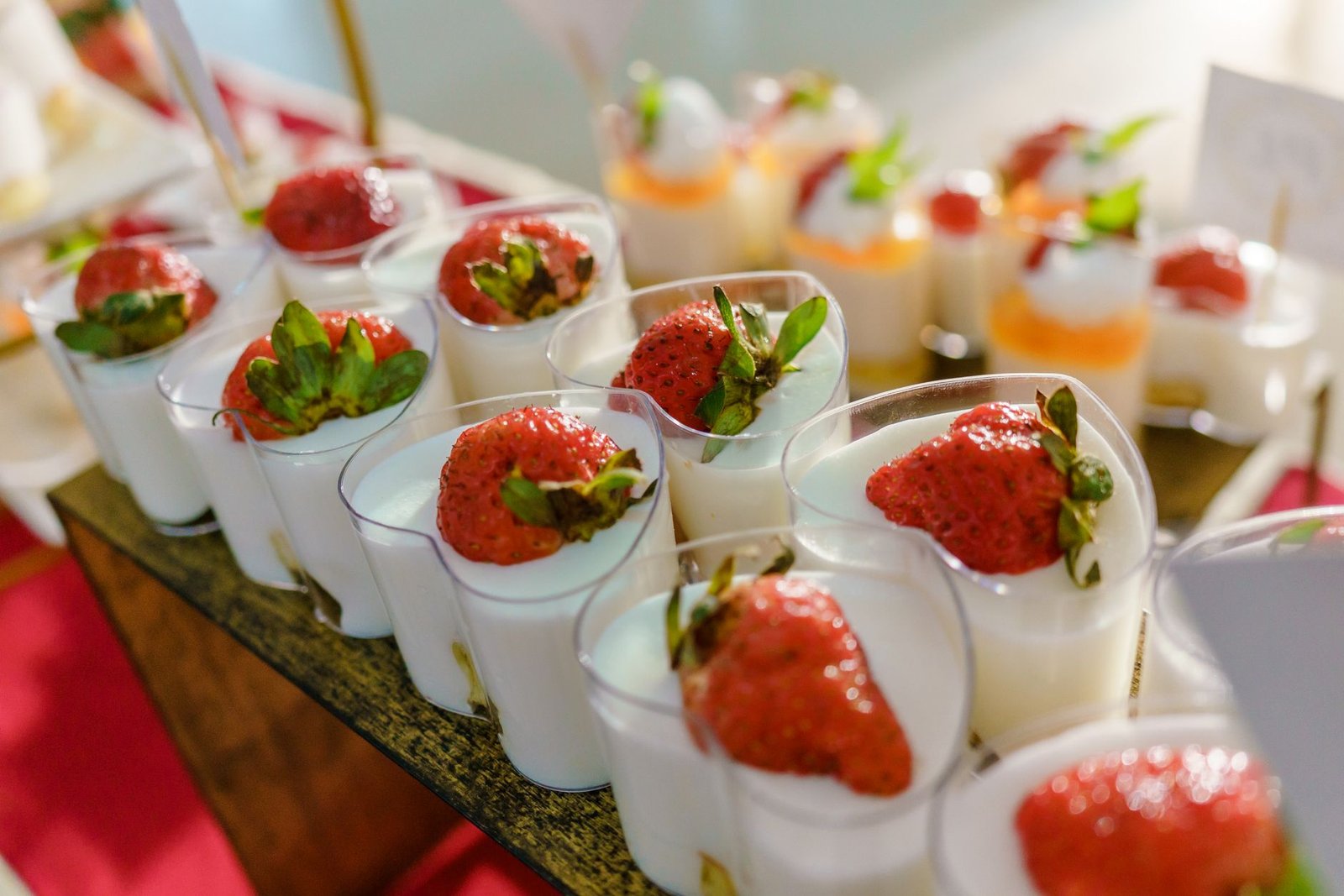 Tasty strawberry-topped yogurt dessert cups beautifully arranged for a sweet treat.