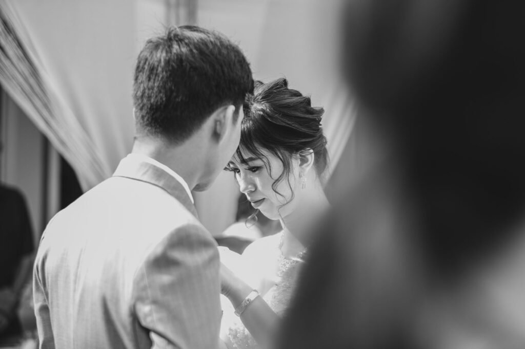 A tender black and white wedding moment capturing a couple in Vietnam.
