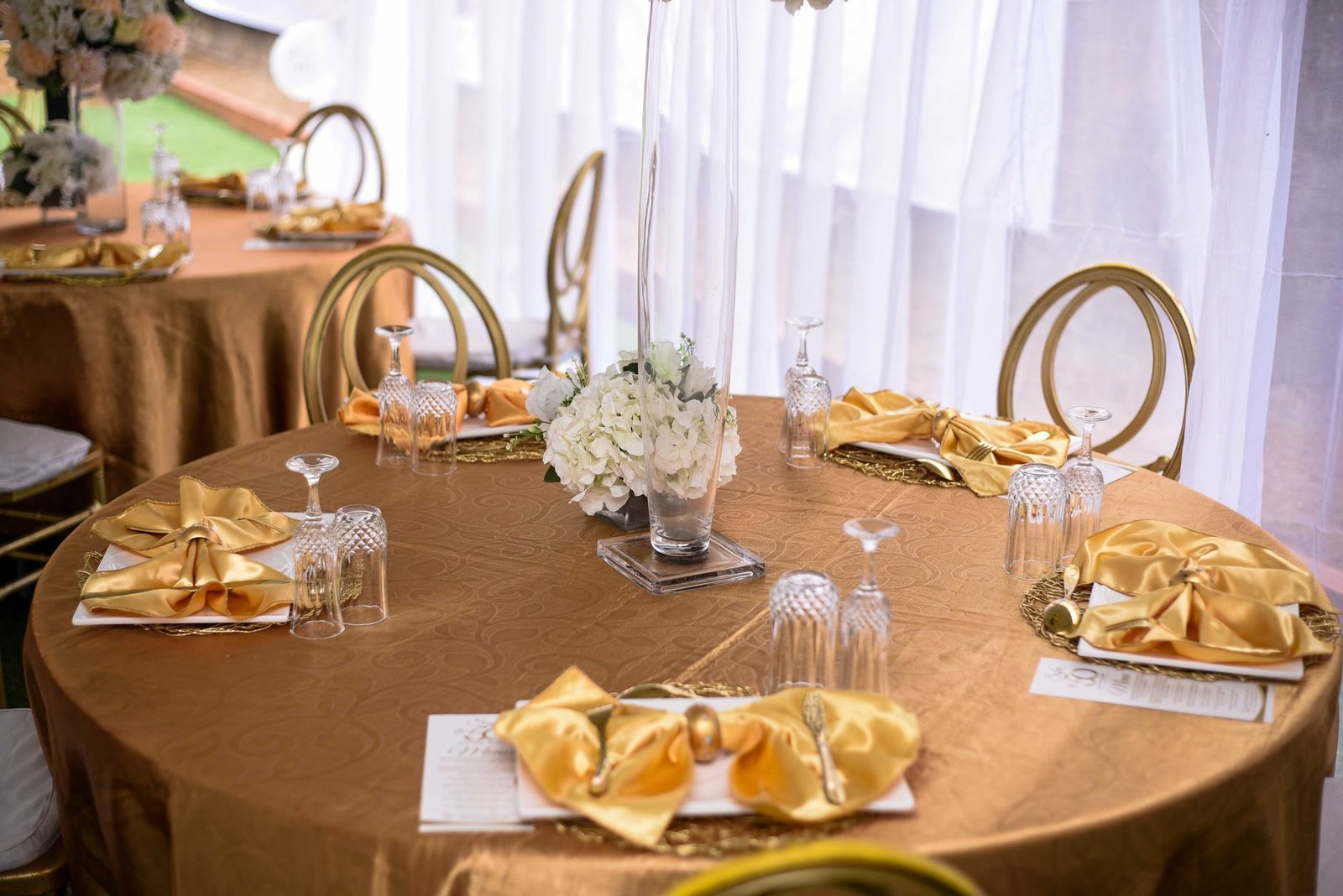 Sophisticated gold table setting with elegant decor for an upscale dining experience.