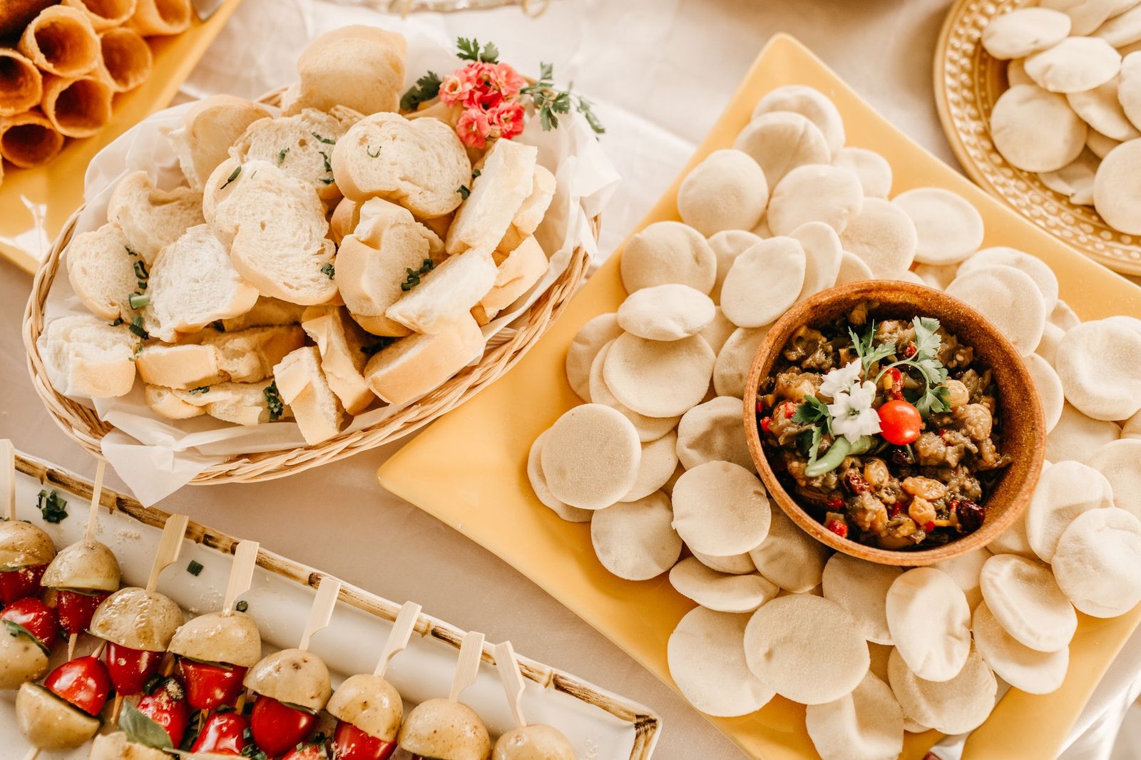 Delicious homemade appetizer platter with breads, dip, and vegetable skewers, perfect for gatherings.