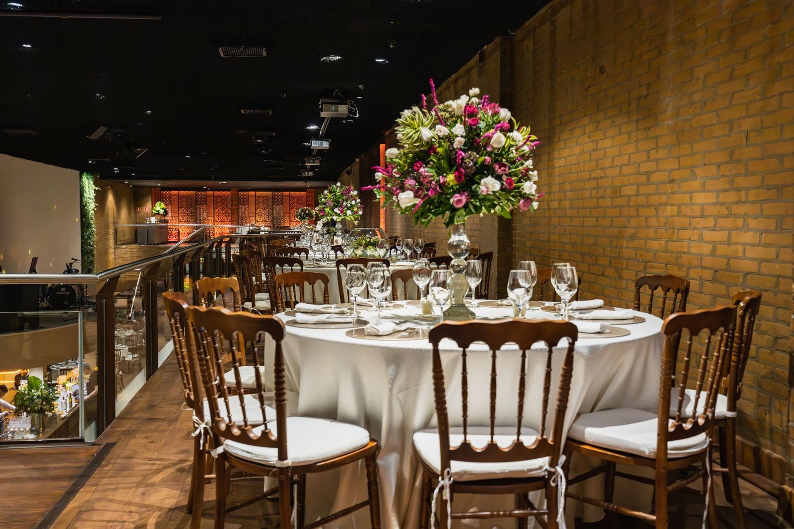 Beautifully arranged dining table with flowers for an elegant indoor wedding reception.