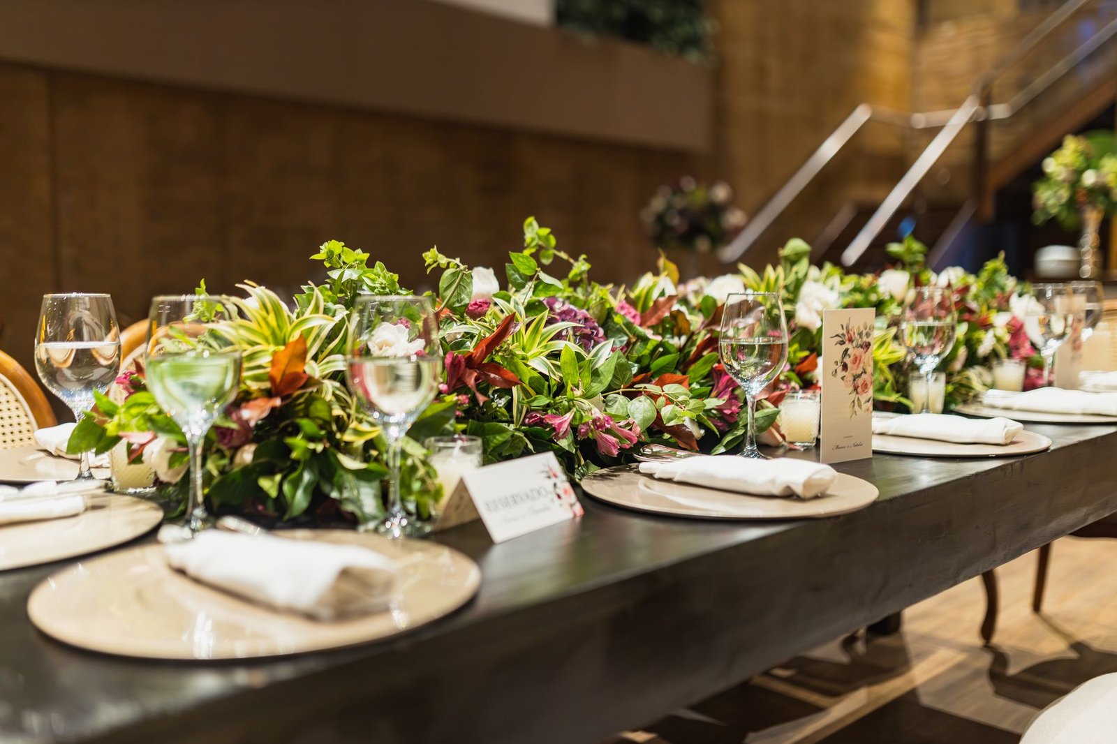 Elegantly decorated table with floral arrangements and glassware, perfect for a celebration or special event.