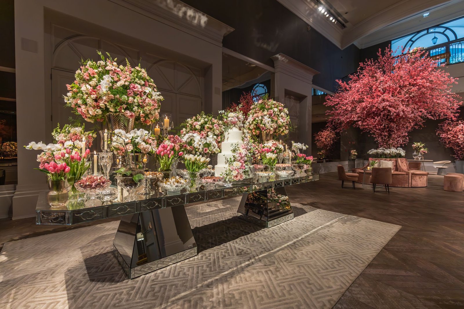 Elegant indoor wedding reception with lavish floral displays and a sophisticated decor theme.