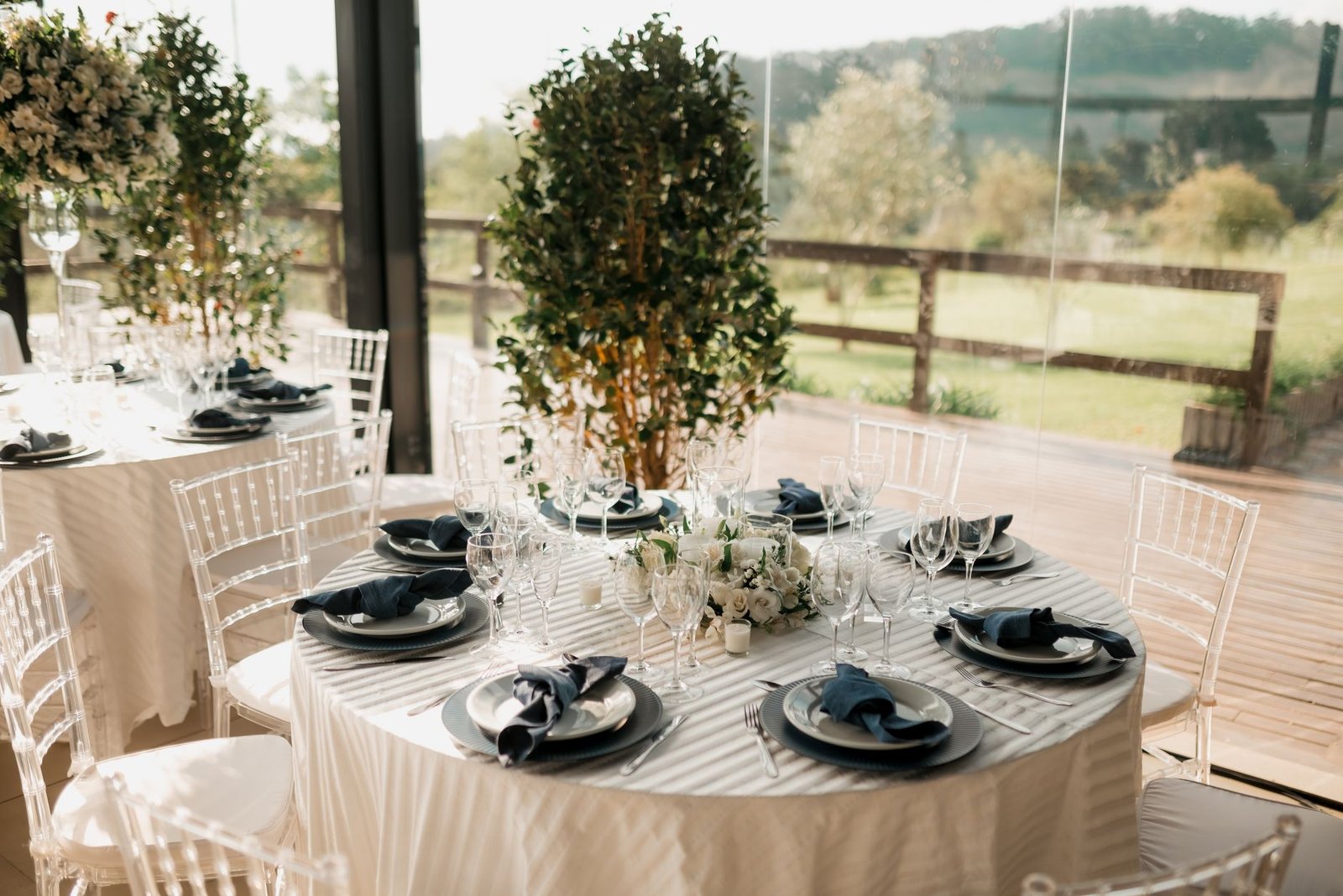 Beautifully arranged wedding table with elegant decor and scenic outdoor view.