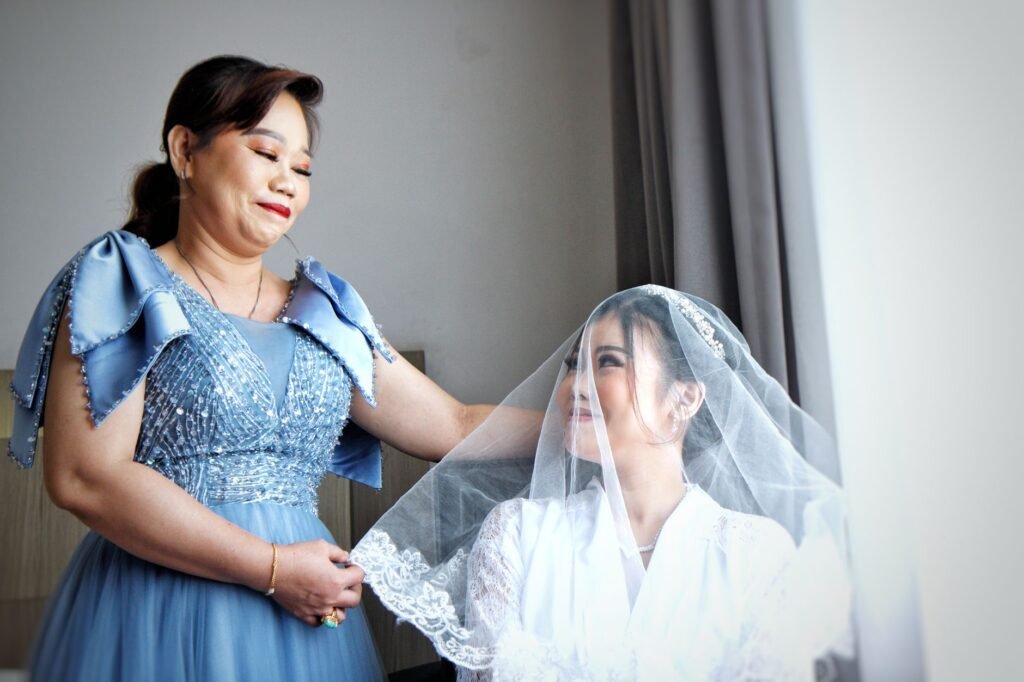 A touching moment between a bride and her mother as they prepare for the wedding ceremony, indoors.