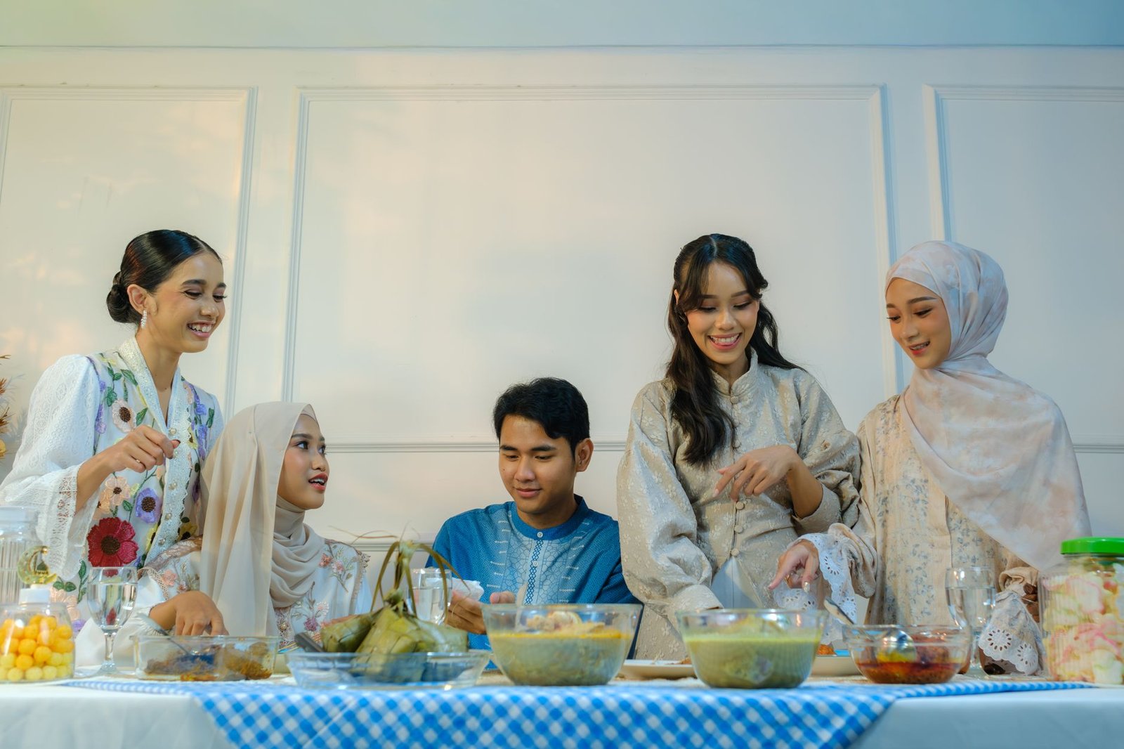 Group of young adults enjoying festive meal celebrating Eid al-Fitr in Jakarta.