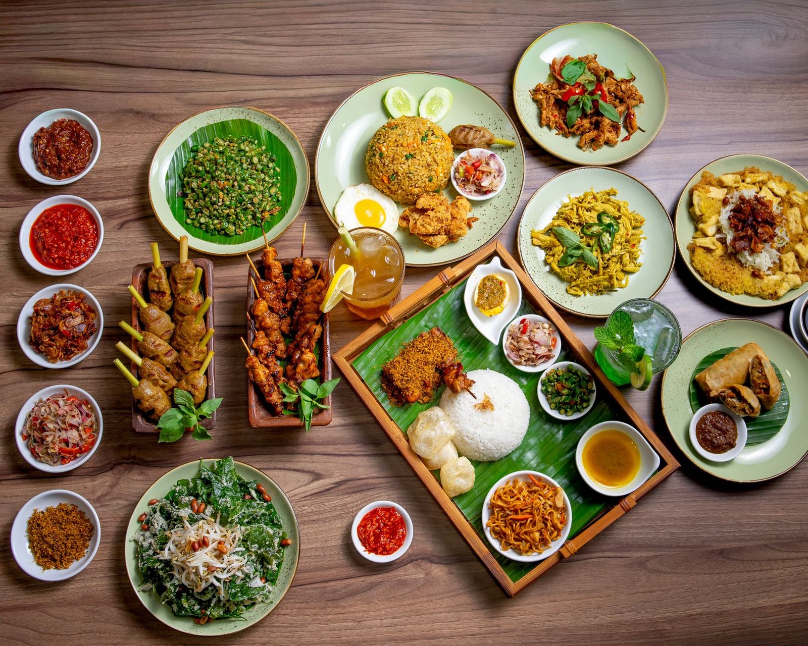 A vibrant spread of authentic Indonesian dishes featuring Nasi Goreng, satay skewers, and sambal sauces.