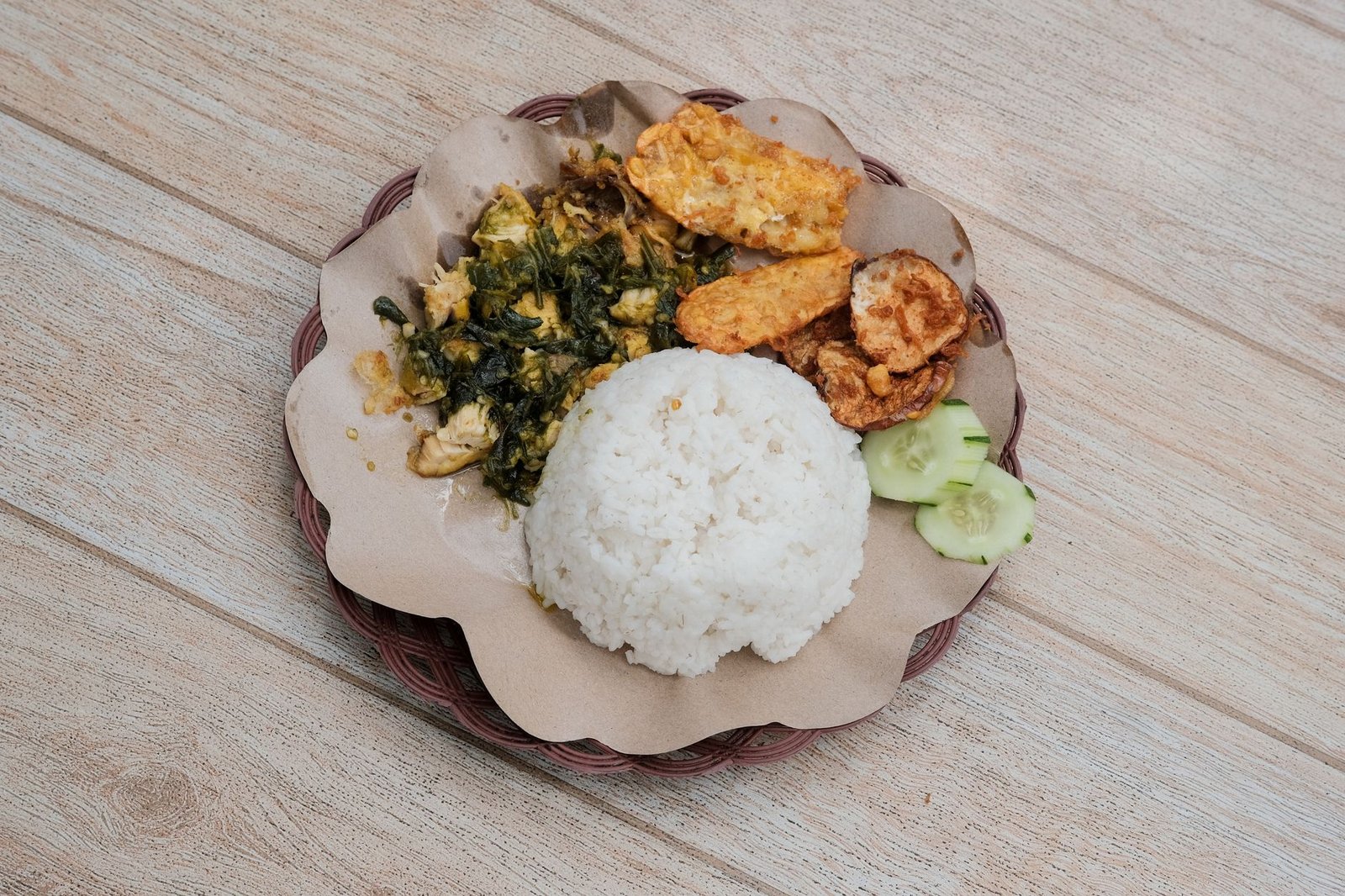 Delicious Indonesian Nasi Padang served with fried tempeh and vegetables for an authentic meal.