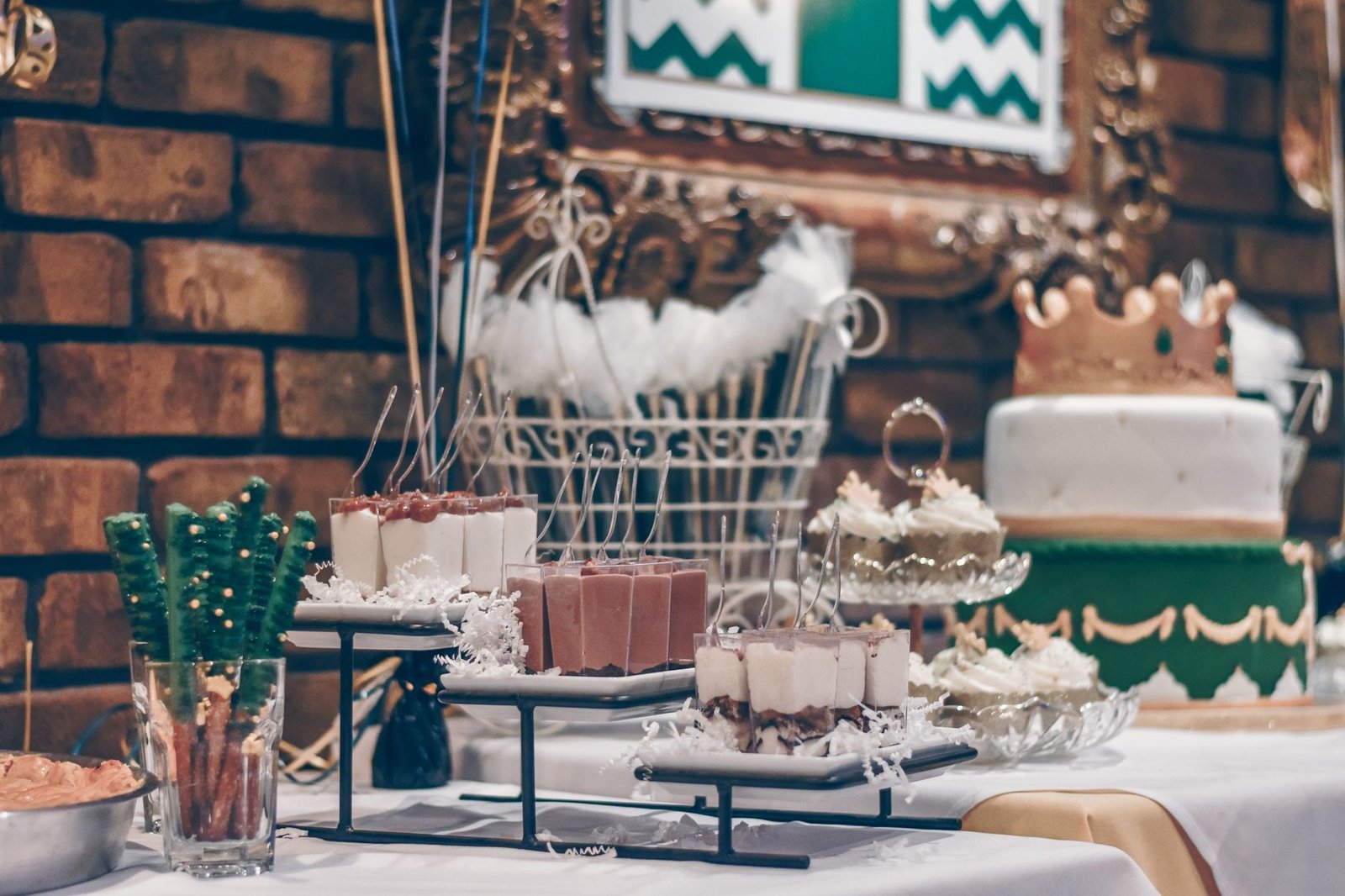 Beautifully decorated dessert table featuring cake and assorted sweets at a celebration event.
