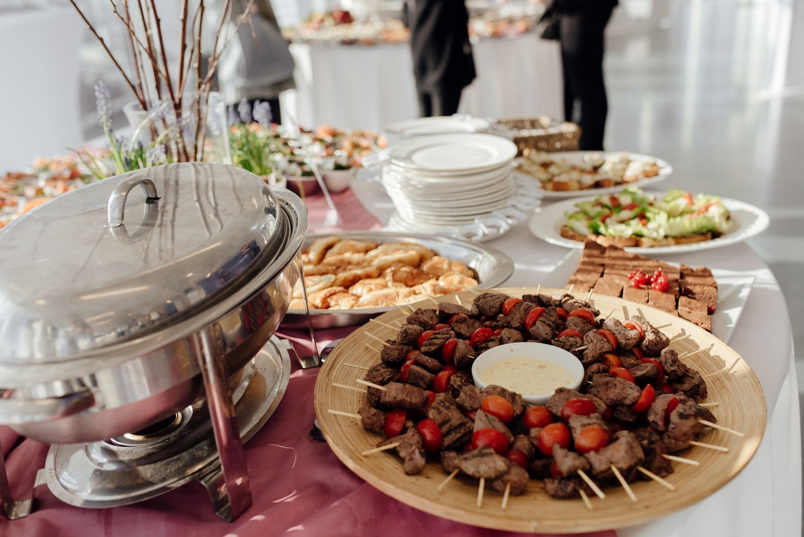 Buffet elegan dengan daging tusuk, salad segar, dan berbagai makanan penutup di acara festif.