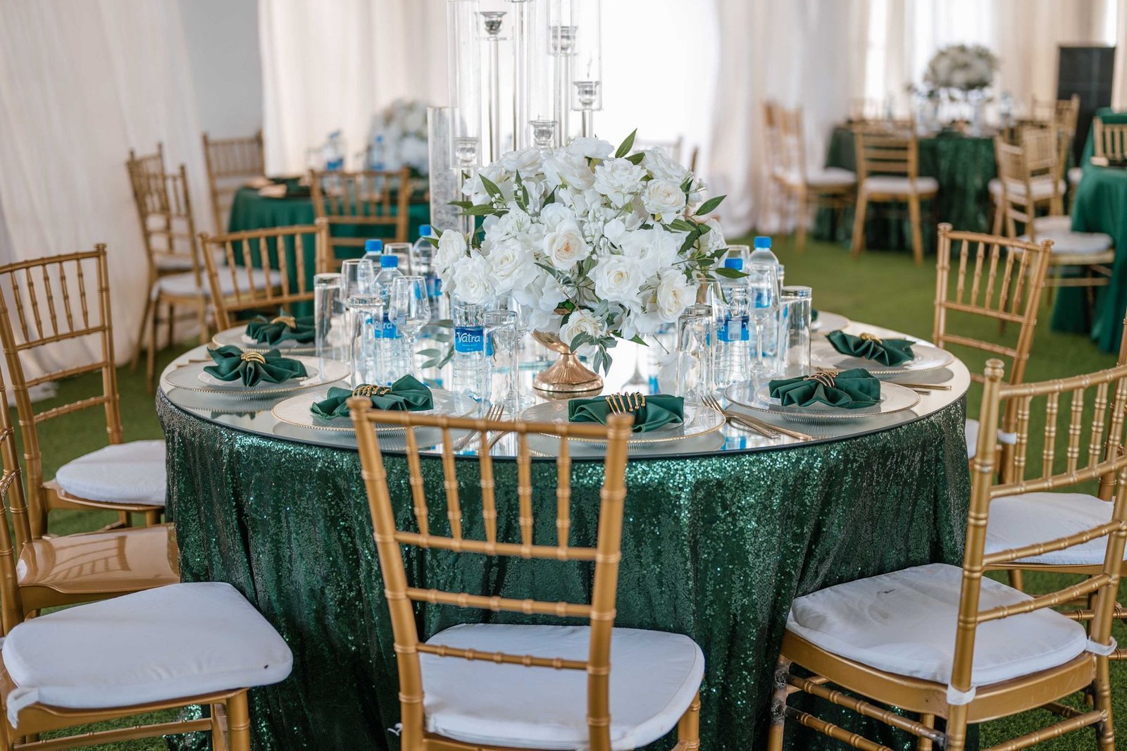 A beautifully decorated wedding reception table with white flowers and elegant tableware.