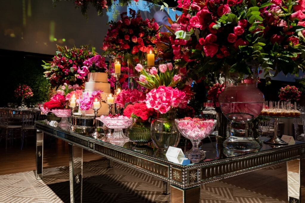 Luxurious wedding reception featuring a beautifully decorated table with pink floral arrangements and elegant glassware.
