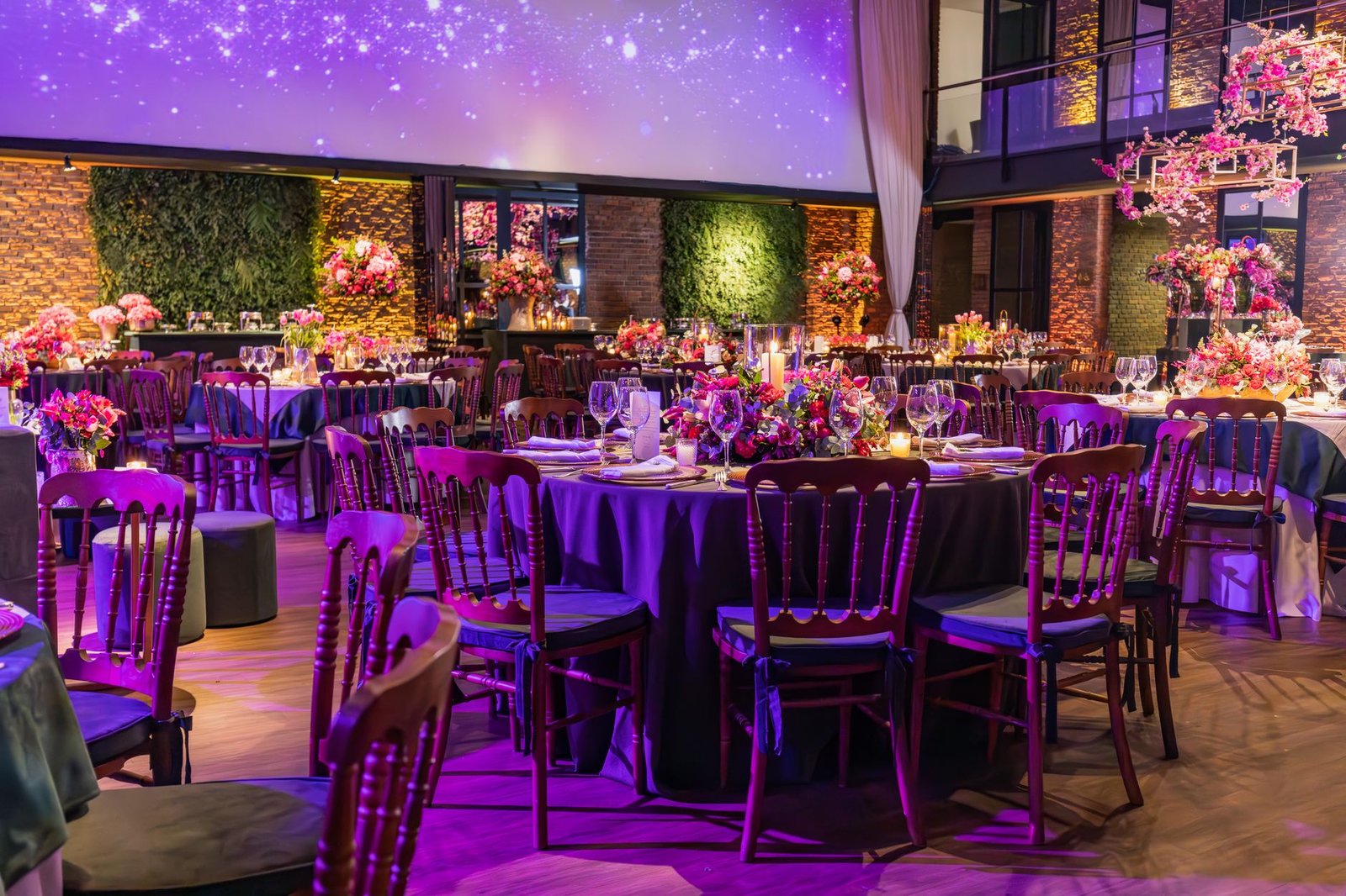 Lavishly decorated wedding reception with floral arrangements and elegant table settings.