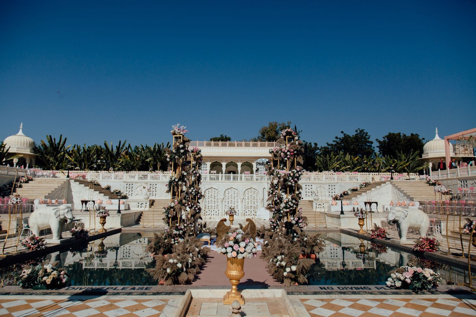 Stunning outdoor Indian wedding venue adorned with floral arrangements and traditional decor.