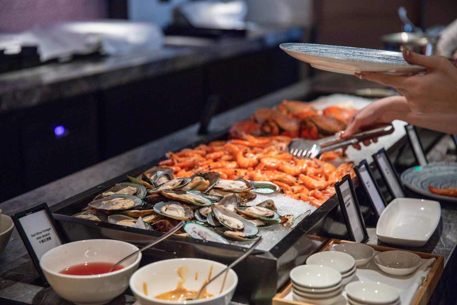 A tempting seafood buffet featuring fresh oysters and prawns, inviting diners to indulge.